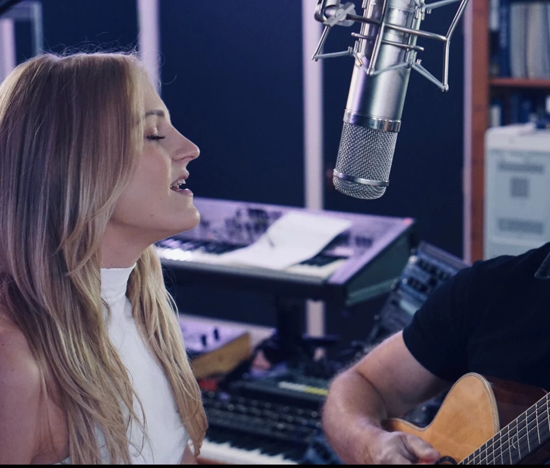 Rachel singing at the studio microphone